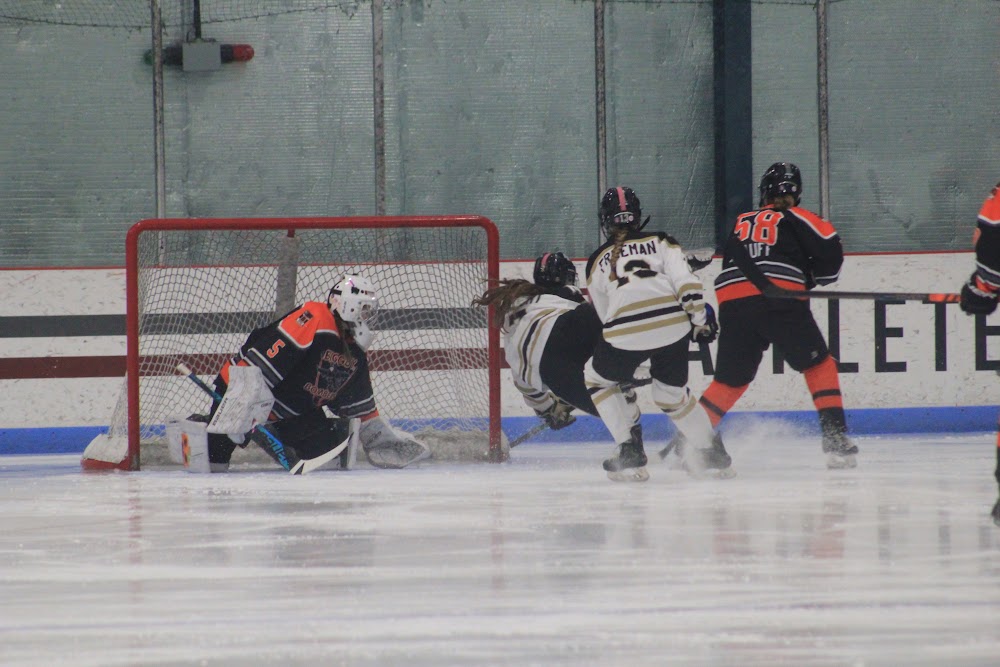 Scramble in front of our net, Rachael K. (#58) closing in.